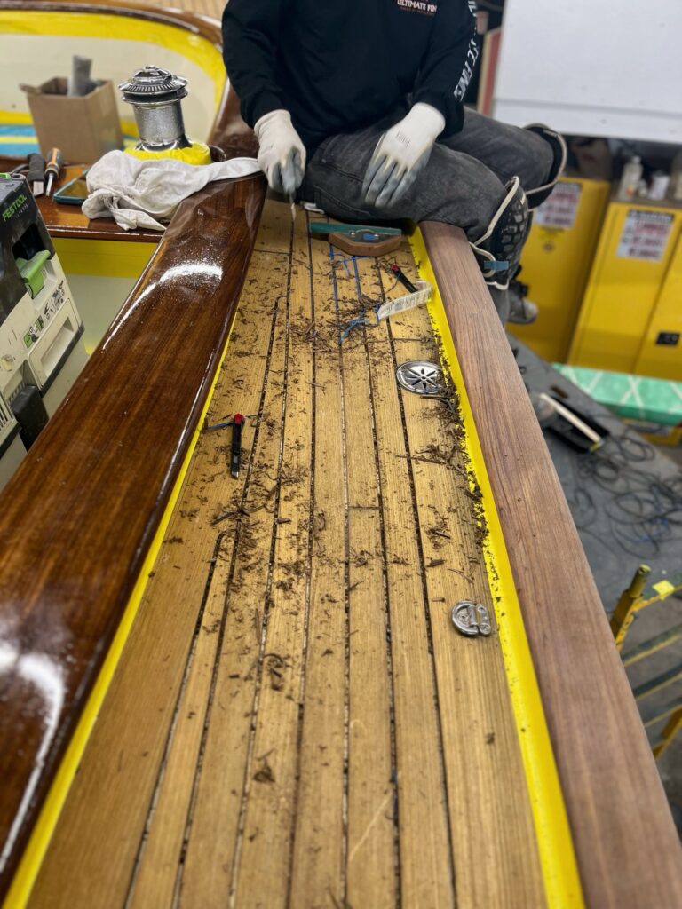 Reaming out old compound from teak deck for re-seam, February 6, 2026 (Photo: Ted Fontaine)